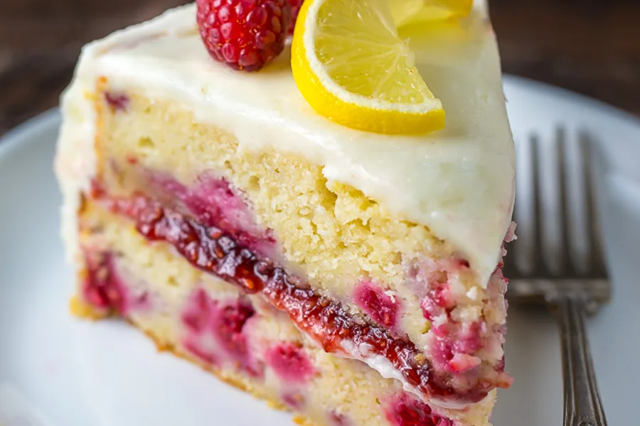 Slice of lemon raspberry cake with fresh raspberries